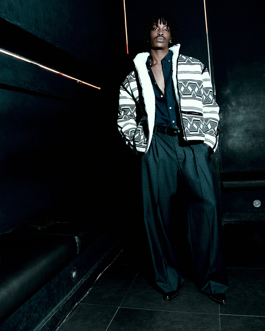 Men in a club wearing ikat fleece jacket with fluid pants.