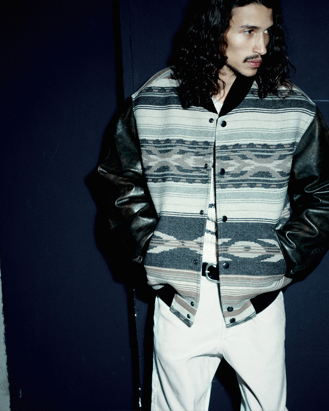 Men wearing ikat printed leather jacket with his hands on.