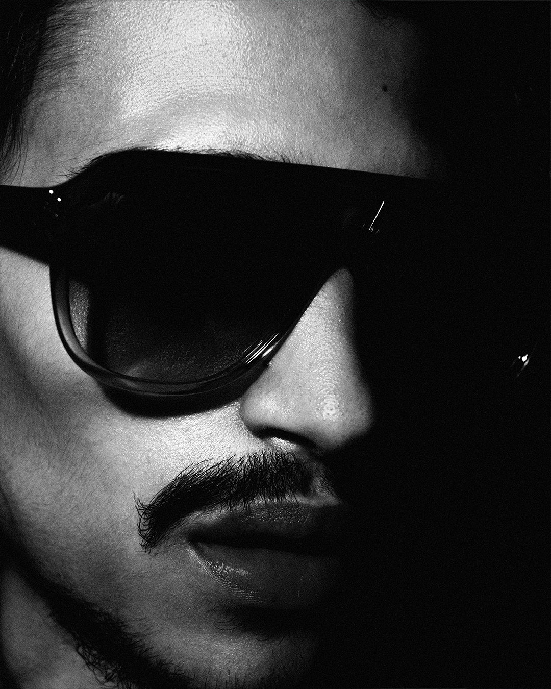 Focus on the eyewear worn by a men model.