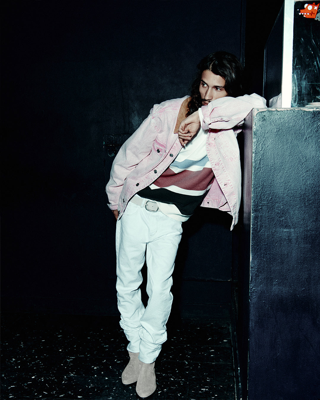 Men posing in the club with pink denim jacket.