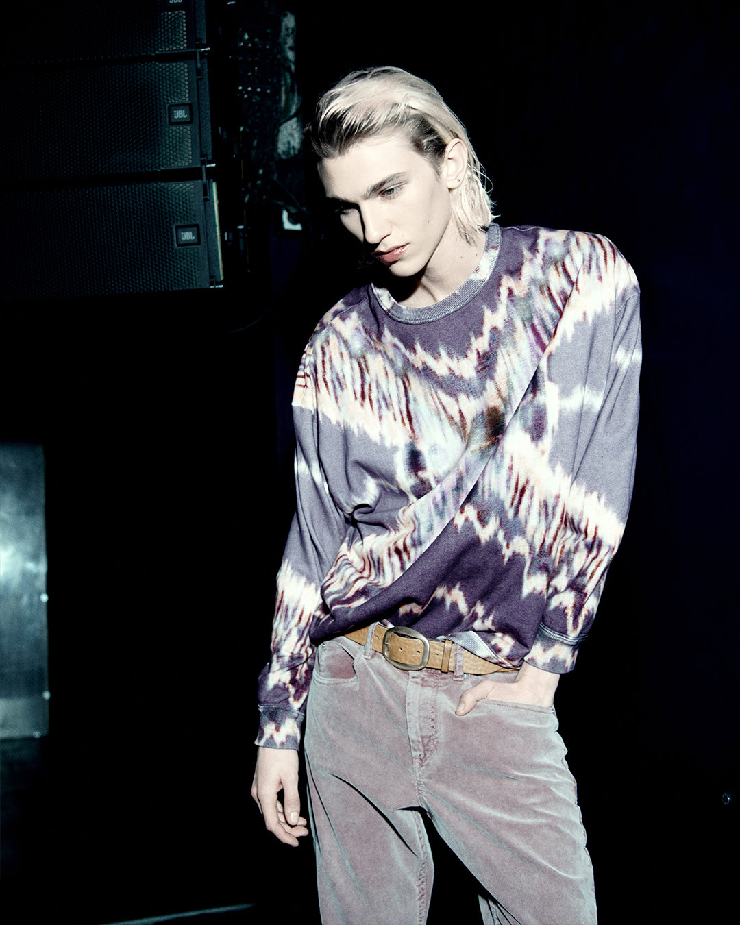 Men model wearing watercolor purple and pink denim pants.