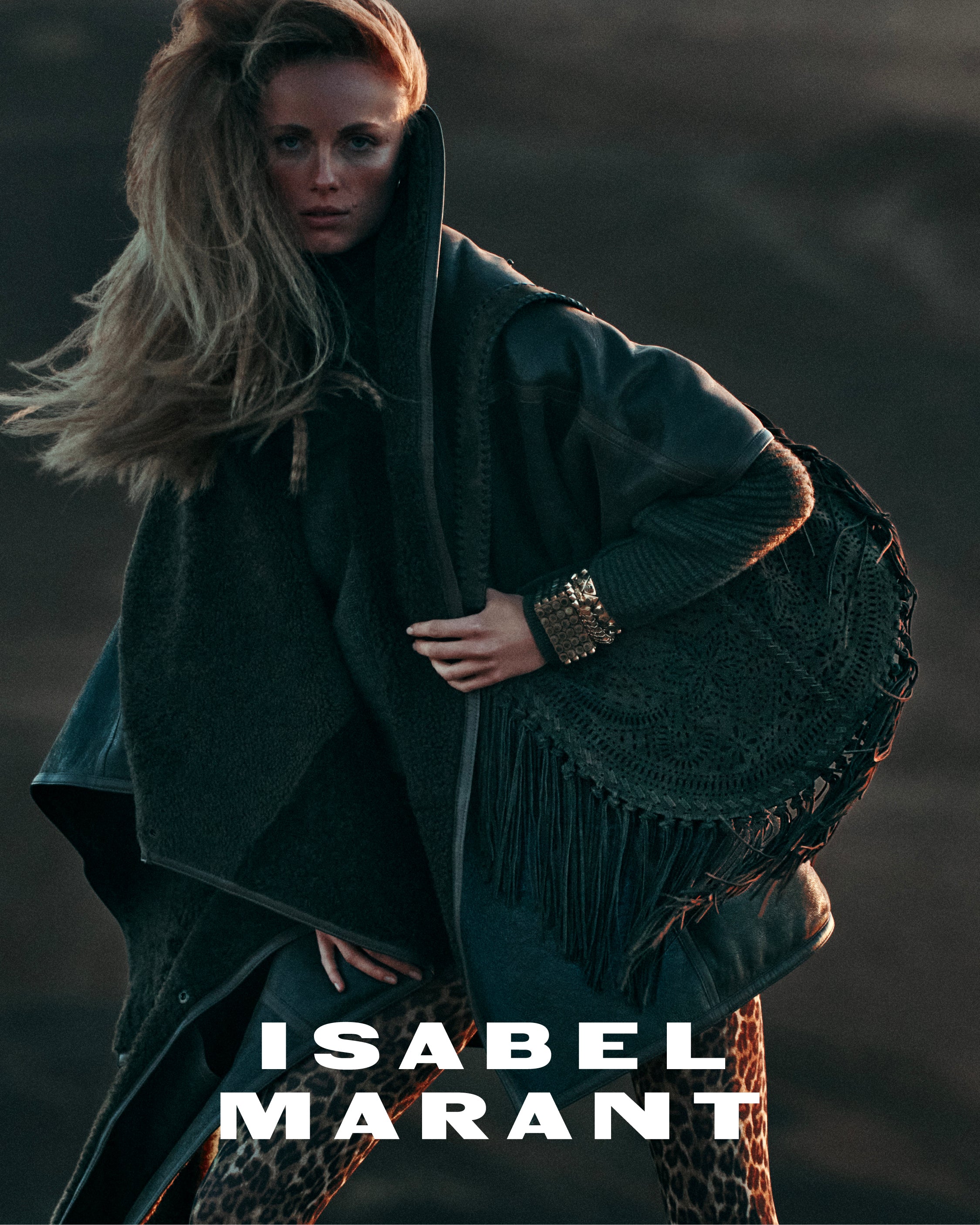 Women model wearing leather jacket and Oskan Hobo fringed.