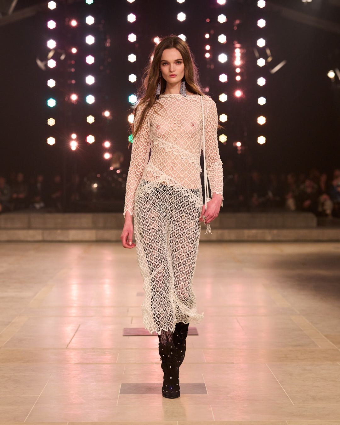 Lulu Tenney walking for the FW25 show with white lace dress.