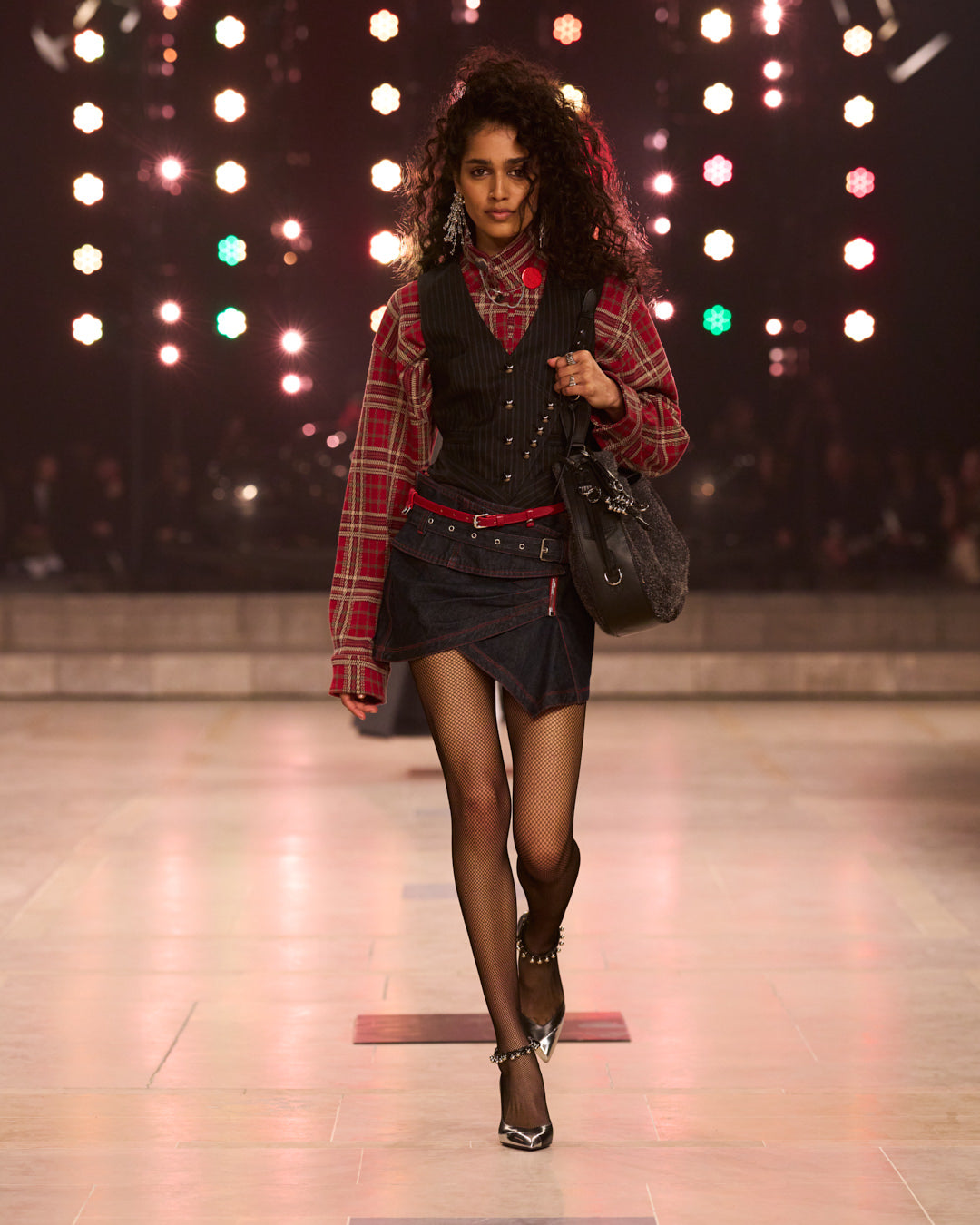 Model with scottich checked shirt, punk mood with the blakc mini skirt and stiletto with studs details.