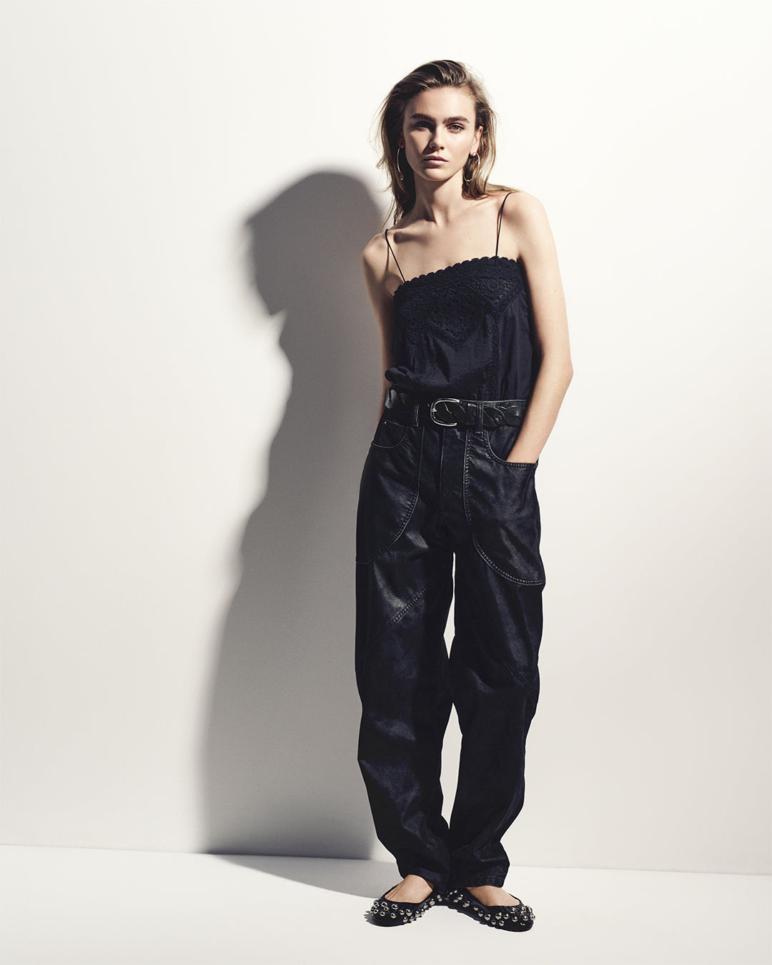 The model wears the Gaelia strapless top in cotton voile with the Kelvina pants in faux leather and the black Belna studded ballerina flats.